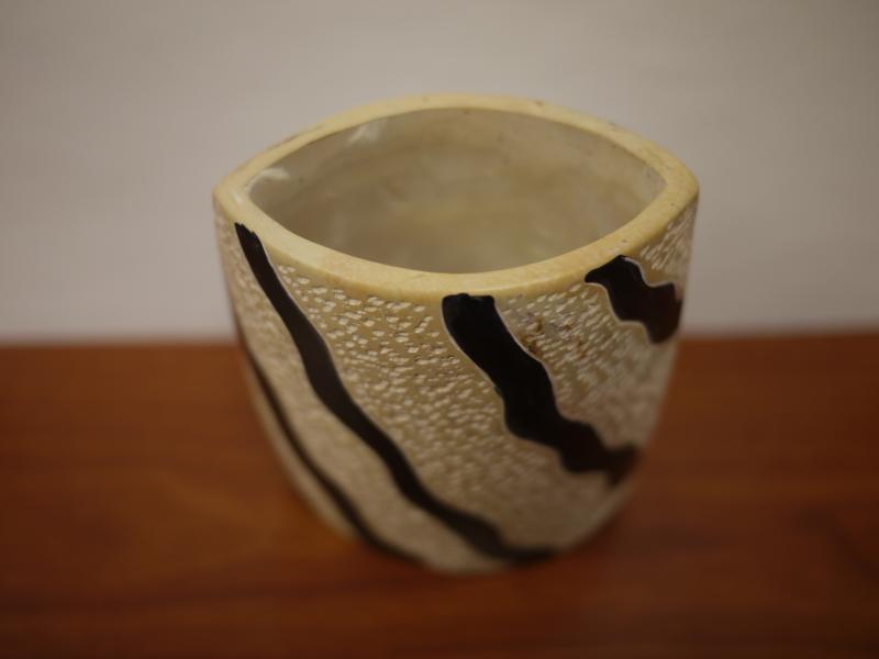 a cup with black line designs