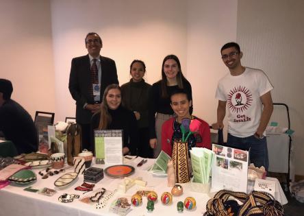 A group of individuals manning a table full of products at an event