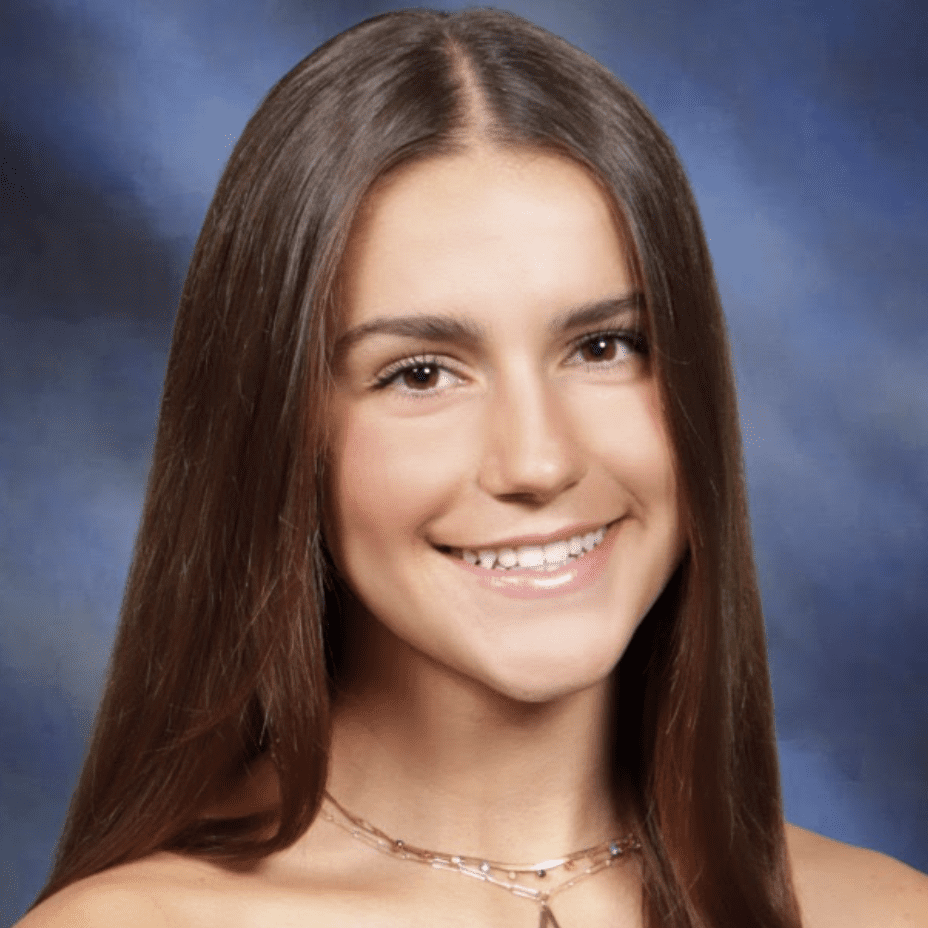 Portrait of a young woman with long brown hair and a friendly smile.