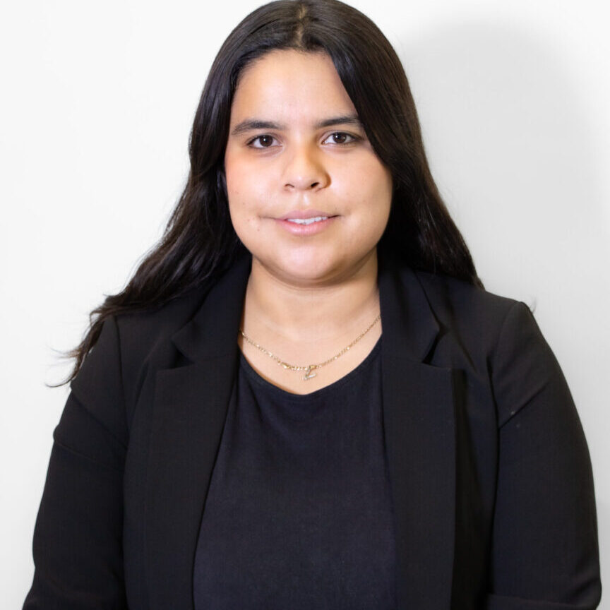 Professional woman with long dark hair wearing a black blazer.